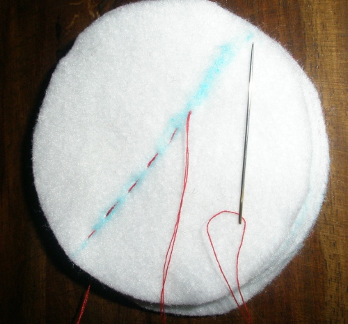 stitch all felt circles together down center with matching thread (not contrasting as shown)
