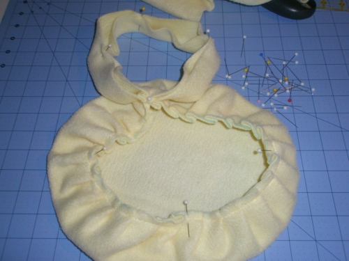 marking the hat and brim into equal quarters, stretching brim to fit hat piece within each section as you sew